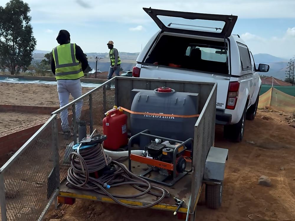 Propserve bakkie and equipment trailer mobilised on a hillside residential development