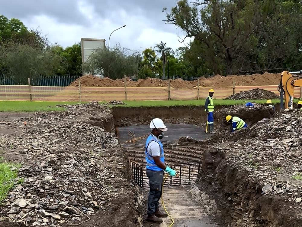 Open foundation trench and rebar being treated with termiticide ahead of the slab pour